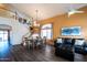 Inviting living and dining area with soaring ceilings, stylish furnishings, and wood laminate flooring at 896 E Dragon Fly Rd, San Tan Valley, AZ 85143