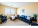 Loft featuring a gray chaise lounge and black futon with plenty of natural light at 896 E Dragon Fly Rd, San Tan Valley, AZ 85143