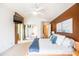 Light-filled main bedroom includes a ceiling fan and a view into the main bathroom at 896 E Dragon Fly Rd, San Tan Valley, AZ 85143