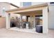 Covered patio with an outdoor dining set and barbecue grill, ideal for entertaining at 896 E Dragon Fly Rd, San Tan Valley, AZ 85143