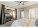 Bright main bedroom with sliding glass door to outdoor patio and en-suite bathroom at 9455 E Raintree Dr # 1009, Scottsdale, AZ 85260