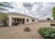 Covered back patio overlooks a spacious yard with low maintenance landscaping and a fire pit at 9612 W Mariposa Grande --, Peoria, AZ 85383