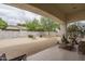 Spacious backyard featuring desert landscaping, a built-in fire pit, and a covered patio area for seamless indoor-outdoor living at 9612 W Mariposa Grande --, Peoria, AZ 85383