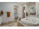 Bathroom featuring a soaking tub, tiled floors, and a neutral color palette, creating a tranquil and inviting atmosphere at 9612 W Mariposa Grande --, Peoria, AZ 85383