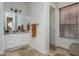 A bathroom with a double vanity featuring granite countertops, wooden window blinds, and tiled floors for simple luxury at 9612 W Mariposa Grande --, Peoria, AZ 85383