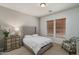 Inviting bedroom with a gray upholstered headboard bed, warm neutral walls, and natural light from the window at 9612 W Mariposa Grande --, Peoria, AZ 85383