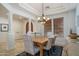 Bright dining space with a wood table, elegant chandelier and stylish chairs under a coffered ceiling at 9612 W Mariposa Grande --, Peoria, AZ 85383