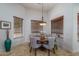 An inviting dining area featuring a round table, comfortable seating, and soft, natural light streaming through the windows at 9612 W Mariposa Grande --, Peoria, AZ 85383