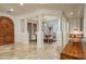 Elegant dining space with architectural columns and a stylish chandelier, complemented by a rustic wooden door at 9612 W Mariposa Grande --, Peoria, AZ 85383