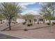 Single-story home featuring stone accents, desert landscaping, and a tile roof at 9612 W Mariposa Grande --, Peoria, AZ 85383