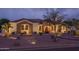 Beautiful single-story home with stone accents, a terracotta roof, and a well-manicured desert landscape under twilight at 9612 W Mariposa Grande --, Peoria, AZ 85383