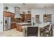 Well-appointed kitchen with custom cabinets, granite countertops, and a stone-accented range hood at 9612 W Mariposa Grande --, Peoria, AZ 85383