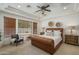 Serene main bedroom with a plush leather bed, tray ceilings, and a cozy sitting area at 9612 W Mariposa Grande --, Peoria, AZ 85383