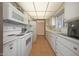 Bright kitchen with white appliances and ample counter space at 9750 W Royal Ridge Dr, Sun City, AZ 85351