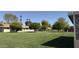 A desert home with a large open grassy backyard at 9814 W Shasta Dr, Sun City, AZ 85351