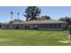 A sprawling backyard with a well maintained lawn, patio and desert landscaping at 9814 W Shasta Dr, Sun City, AZ 85351