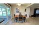 Dining area featuring a wooden table, four chairs, tile flooring, and sliding glass doors to the patio at 9814 W Shasta Dr, Sun City, AZ 85351