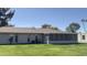 Exterior view of the home, highlighting the enclosed patio and well-maintained lawn at 9814 W Shasta Dr, Sun City, AZ 85351