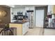 Bright kitchen featuring white cabinetry, stainless steel appliances, granite counters, and tile floors at 9814 W Shasta Dr, Sun City, AZ 85351