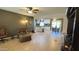 Open-concept living room featuring tile flooring, ceiling fans, and seamless flow into the updated kitchen at 9814 W Shasta Dr, Sun City, AZ 85351