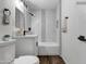 Bright bathroom featuring white fixtures, black hardware, and modern tile design at 1006 E Weber Dr, Tempe, AZ 85288