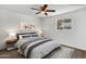 Well-lit bedroom with a ceiling fan, wood-look floors, and a window for natural light at 1006 E Weber Dr, Tempe, AZ 85288