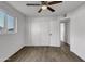 Bedroom features wood-look floors, a window, a ceiling fan, and a closet at 1006 E Weber Dr, Tempe, AZ 85288