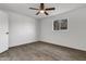 Bedroom features wood-look floors, a window, and a ceiling fan at 1006 E Weber Dr, Tempe, AZ 85288