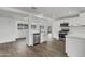 Modern eat-in kitchen features stainless steel appliances, white cabinetry, and luxury vinyl plank flooring at 1006 E Weber Dr, Tempe, AZ 85288