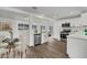 Modern eat-in kitchen features stainless steel appliances, white cabinetry, and luxury vinyl plank flooring at 1006 E Weber Dr, Tempe, AZ 85288