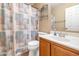 Functional bathroom with a decorative shower curtain, sink vanity, and ample storage, perfect for everyday use at 10461 E Birchwood Ave, Mesa, AZ 85208