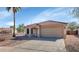 Charming single-story home with a tile roof, desert landscaping, and a two-car garage at 10461 E Birchwood Ave, Mesa, AZ 85208