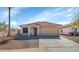 Exterior view of a well-maintained one-story home, with a driveway and desert landscaping at 10461 E Birchwood Ave, Mesa, AZ 85208