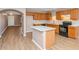 The kitchen has wood cabinets, a kitchen island, and stainless steel appliances at 10461 E Birchwood Ave, Mesa, AZ 85208