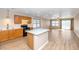 Kitchen island and stainless appliances in an open-concept kitchen and living space at 10461 E Birchwood Ave, Mesa, AZ 85208