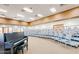 Well lit auditorium with chairs on risers and a piano in the corner at 107 Leisure World --, Mesa, AZ 85206