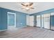 Bright bedroom with ceiling fan, closet, and wood-look flooring at 107 Leisure World --, Mesa, AZ 85206