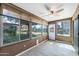 Bright sunroom with multiple windows, ceiling fan, and tile flooring at 107 Leisure World --, Mesa, AZ 85206