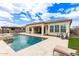 Enjoy the backyard pool and spa, surrounded by a paved patio and lush plants at 11721 W Parkway Ln, Avondale, AZ 85323