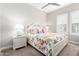 Bedroom featuring shuttered window, neutral wall color, and Queen bed at 11721 W Parkway Ln, Avondale, AZ 85323