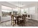 Bright dining area with a wood table, upholstered chairs, and backyard views at 11721 W Parkway Ln, Avondale, AZ 85323