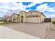 Elegant home featuring a brick driveway leading to a two-car garage with desert landscaping at 11721 W Parkway Ln, Avondale, AZ 85323