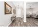 Inviting foyer with wood-look tile, elegant console table, and views into the living area at 11721 W Parkway Ln, Avondale, AZ 85323