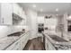 A bright white kitchen with stainless steel appliances, granite countertops, and tile backsplash at 11721 W Parkway Ln, Avondale, AZ 85323