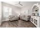 Cozy living room featuring two sofas, a ceiling fan, and stylish decor at 11721 W Parkway Ln, Avondale, AZ 85323