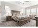 A spacious main bedroom features neutral walls, carpet, shuttered windows, and ceiling fan at 11721 W Parkway Ln, Avondale, AZ 85323