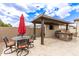 This backyard features a fully equipped outdoor kitchen and stylish dining area at 11721 W Parkway Ln, Avondale, AZ 85323