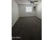 Bedroom with grey carpeting, window, ceiling fan, and built-in shelf at 1215 E Lemon St # 212, Tempe, AZ 85281