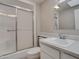 A well-lit bathroom featuring a shower with sliding glass doors and a pristine white sink and vanity at 13235 W Ashwood Dr, Sun City West, AZ 85375