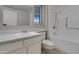 Bright bathroom featuring a white sink, a large mirror, and a shower with a showerhead at 13235 W Ashwood Dr, Sun City West, AZ 85375